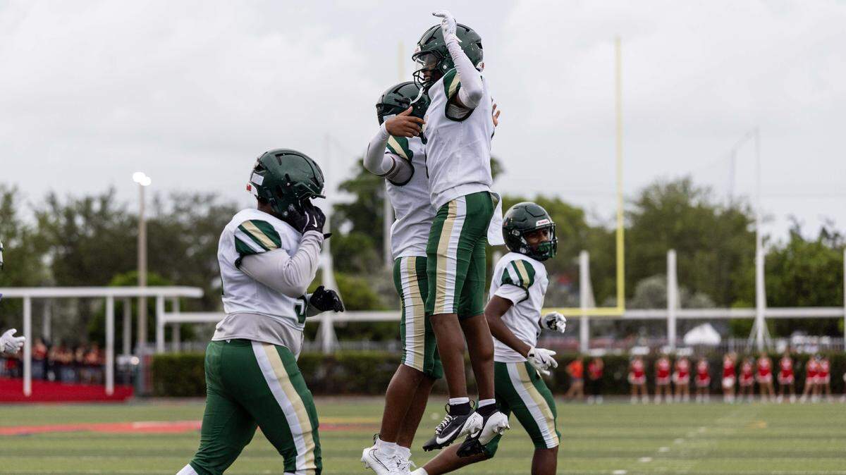 Mater Academy quarterback Nate Merrell Jr. reacts with wide receiver Marcus Dumont (1) after scoring a touchdown during the first half of a high school football game at Doral Academy on Thursday, August 28, 2025, in Doral, Fla.