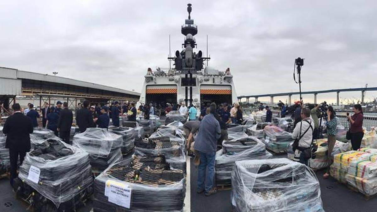 The crew of the Coast Guard cutter Stratton gathers about $700 million worth of cocaine confiscated during a 2017 mission in the Eastern Pacific.