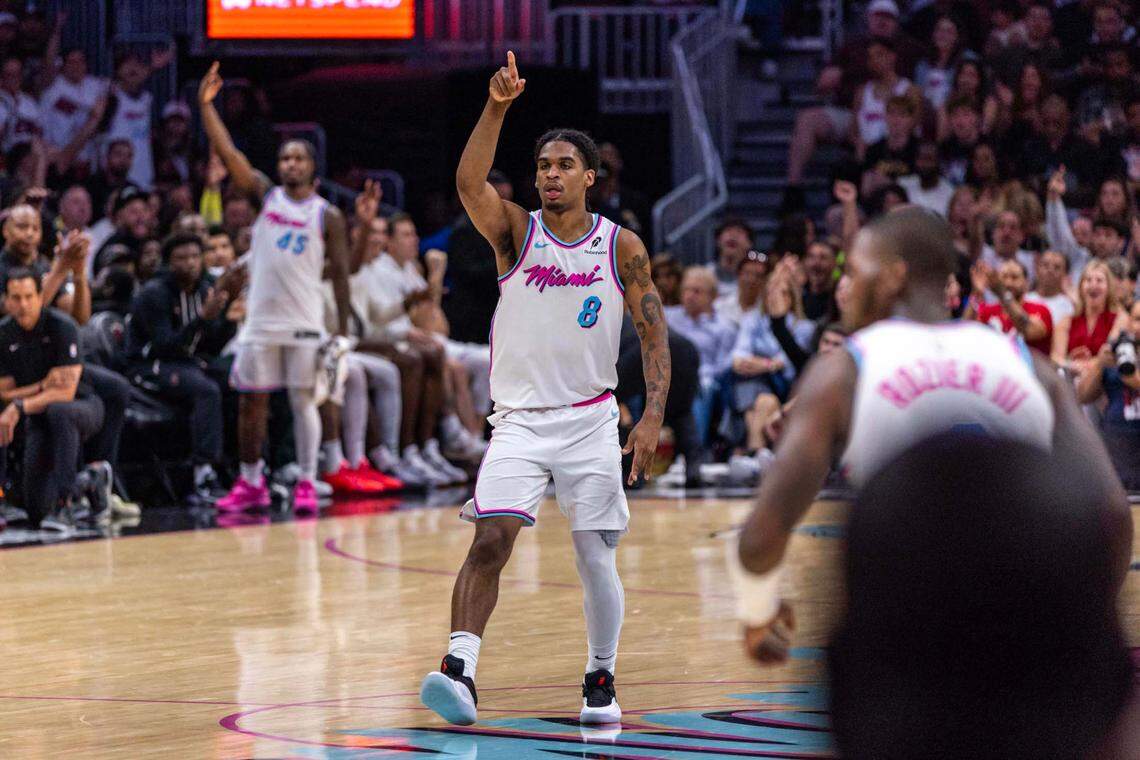 Miami Heat guard Josh Christopher (8) reacts to hitting a three-pointer over Washington Wizards forward Tristan Vukcevic (00) during the second half of an NBA game at Kaseya Center on April 13, 2025, in Miami.