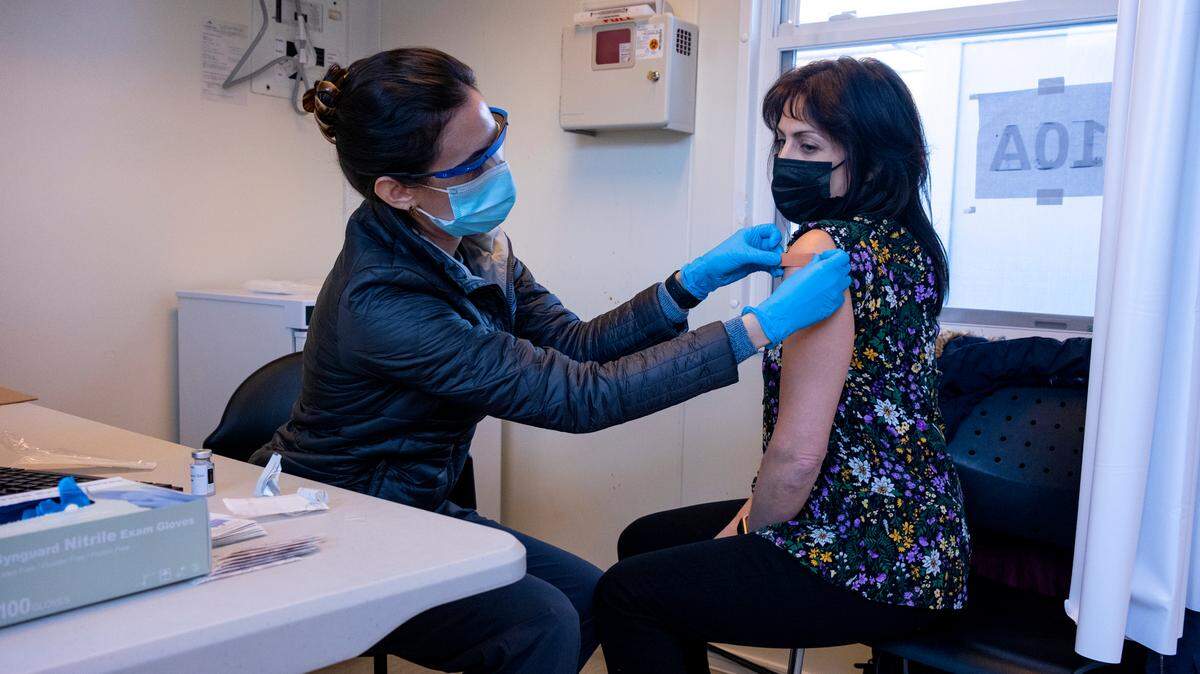 In this file photo, Sarah Gonzalez of New York, a nurse practitioner, applies a band aid after giving Claudia Zain, 47, of New York, her first dose of the COVID-19 vaccine at a New York Health and Hospitals vaccine clinic in the Brooklyn borough of New York Sunday, Jan. 10, 2021.