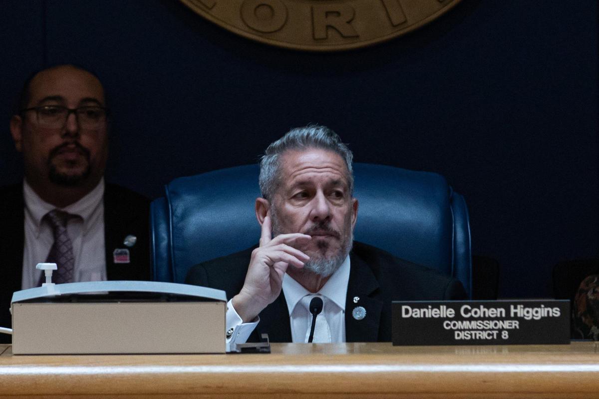 Outgoing Miami-Dade County Commission Chairman Jose “Pepe” Diaz listens as Mayor Daniella Levine Cava reads a statement before her veto is overridden during the commissioners’ meeting on Tuesday, November 15, 2022.