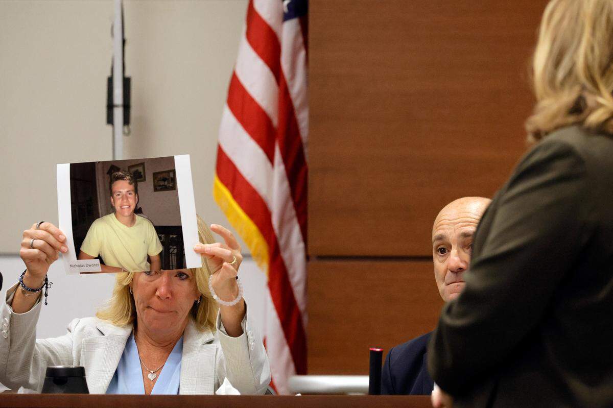 Annika Dworet holds a photo of her son, Nicholas, as she and her husband, Mitch, take the stand to give their witness impact statements during the penalty phase of the trial of Marjory Stoneman Douglas High School shooter Nikolas Cruz at the Broward County Courthouse in Fort Lauderdale on Tuesday, Aug. 2, 2022. Nicholas was killed, and the Dworet’s other son, Alexander, was injured in the 2018 shootings.