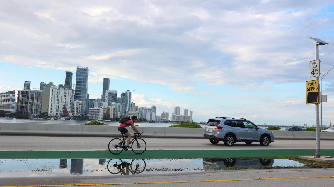 On Monday, a biker rides near the spot where two cyclists were killed a day earlier at the foot of William Powell Bridge on the Rickenbacker Causeway. The pair were struck by a car on a roadway that has been dangerous, sometimes deadly, for cyclists.