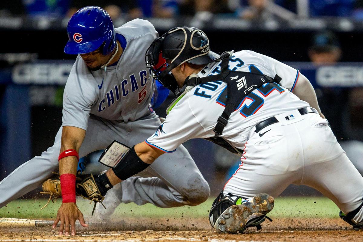 Miami Marlins catcher Nick Fortes (54) attempts to tag out Chicago Cubs base runner Christopher Morel (5) during the eighth inning of an MLB game at loanDepot park in the Little Havana neighborhood of Miami, Florida, on Wednesday, September 21, 2022.