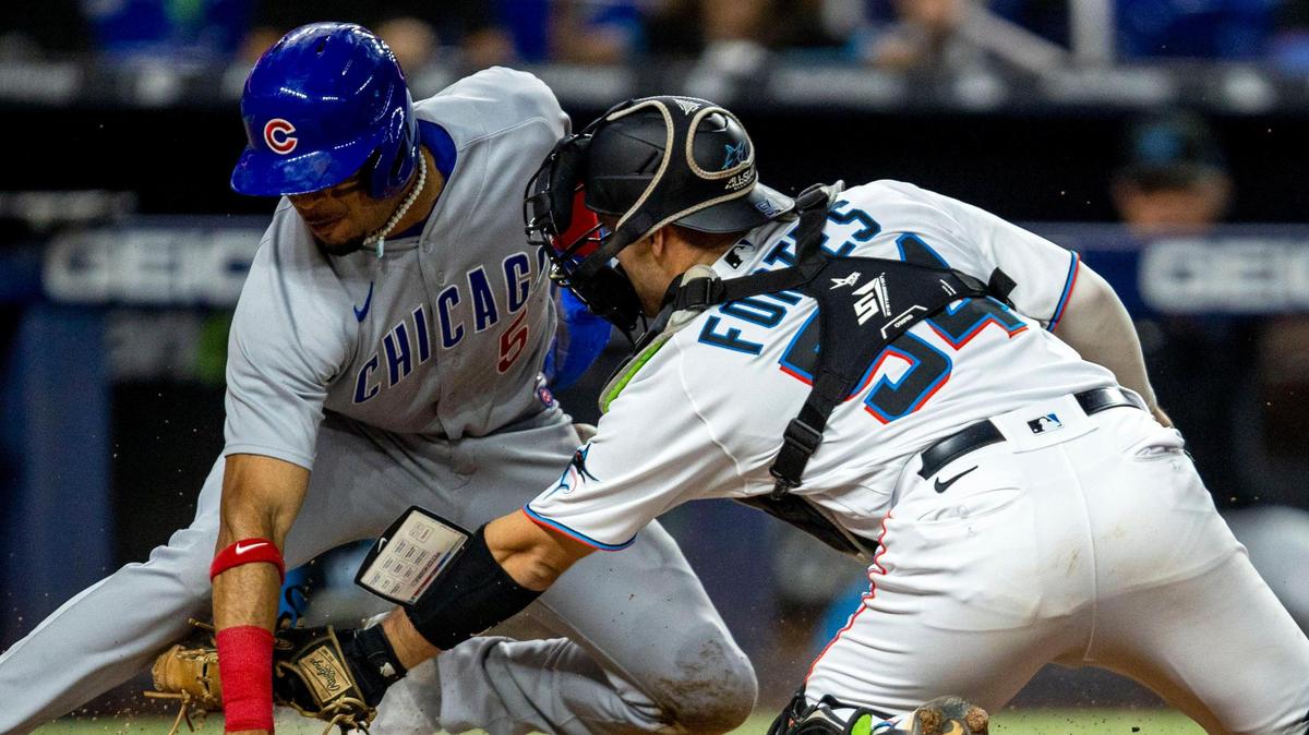 Miami Marlins catcher Nick Fortes (54) attempts to tag out Chicago Cubs base runner Christopher Morel (5) during the eighth inning of an MLB game at loanDepot park in the Little Havana neighborhood of Miami, Florida, on Wednesday, September 21, 2022.