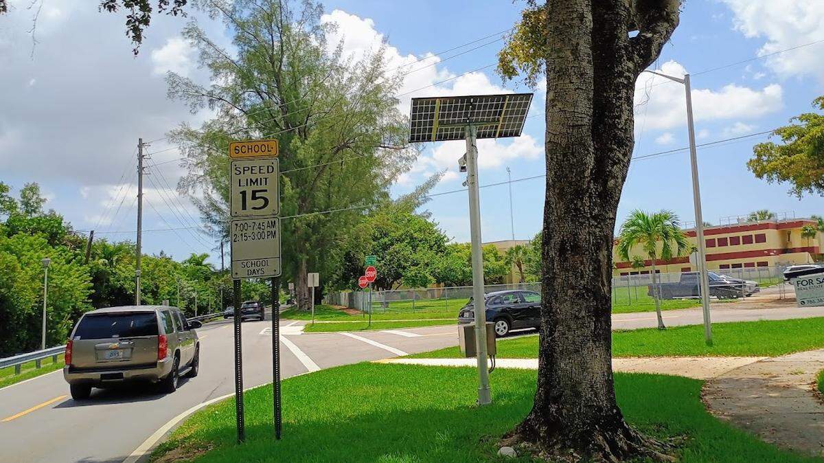A school-zone camera is shown near Miami Springs Senior High School.