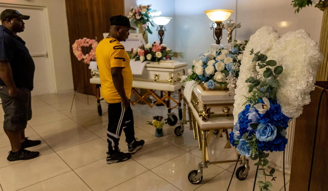 Frantzy Belval, center, father of Laura and Jeffry Belval, approaches the caskets at the viewing for the two children at Emmanuel Funeral Home in North Miami Beach on June 3, 2022. According to police, the 5-year-old girl and 3-year-old boy were strangled by their mother on April 12.