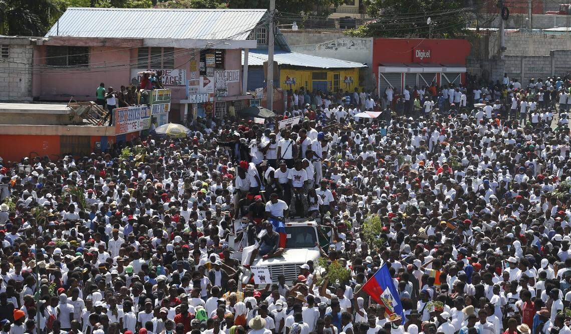 Protesters led by the art community demand the resignation of Haitian President Jovenel Moise as they march through Port-au-Prince, Haiti, Sunday, Oct. 13, 2019. Protests have paralyzed the country for nearly a month, shuttering businesses and schools.