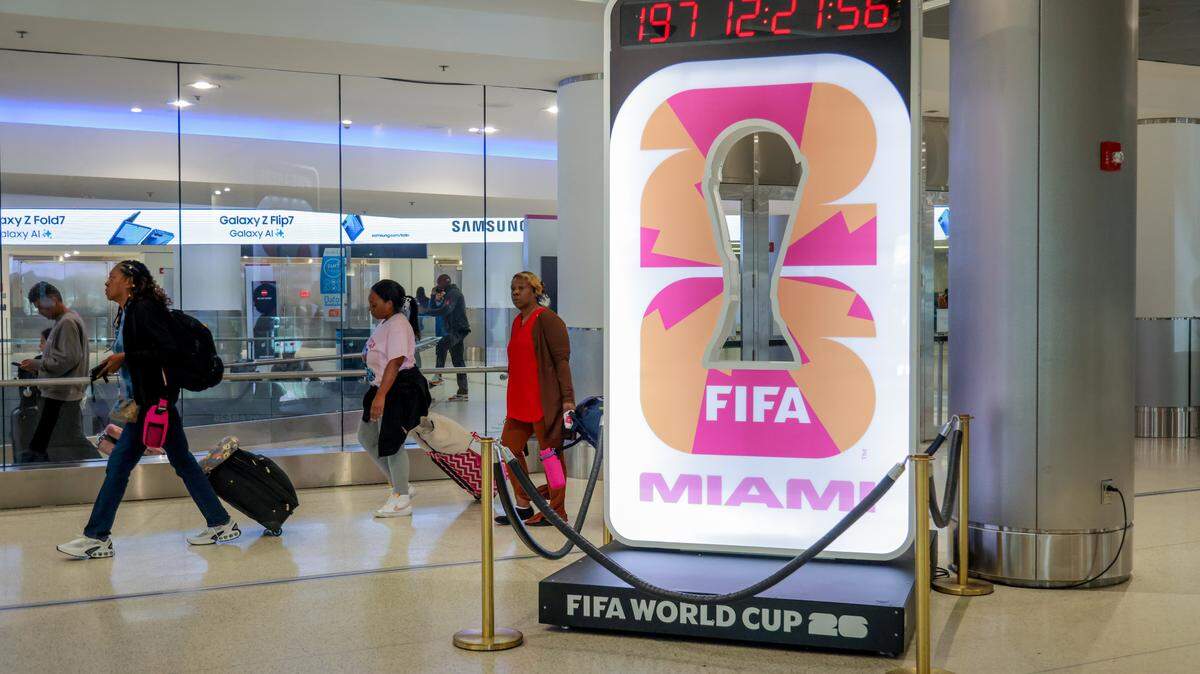 Travelers on Concourse D push their luggage by an installation with a countdown clock signaling the start of the 2026 FIFA World Cup at Miami International Airport on Tuesday, Nov. 25, in Miami, Fla.