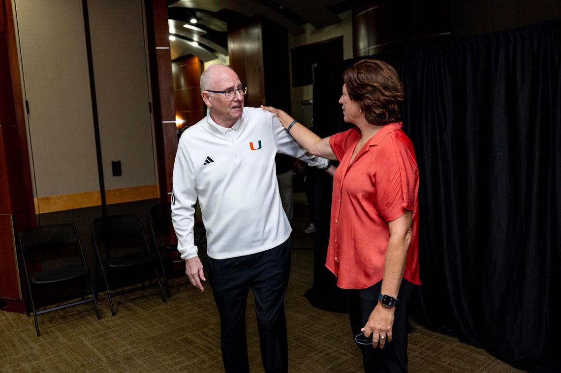 Hurricanes men’s basketball head coach Jim Larrañaga speaks with former UM women’s basketball coach Katie Meier, who retired last April, after a press conference announcing his retirement at the Watsco Center on Thursday, Dec. 26, 2024, in Coral Gables, Fla.