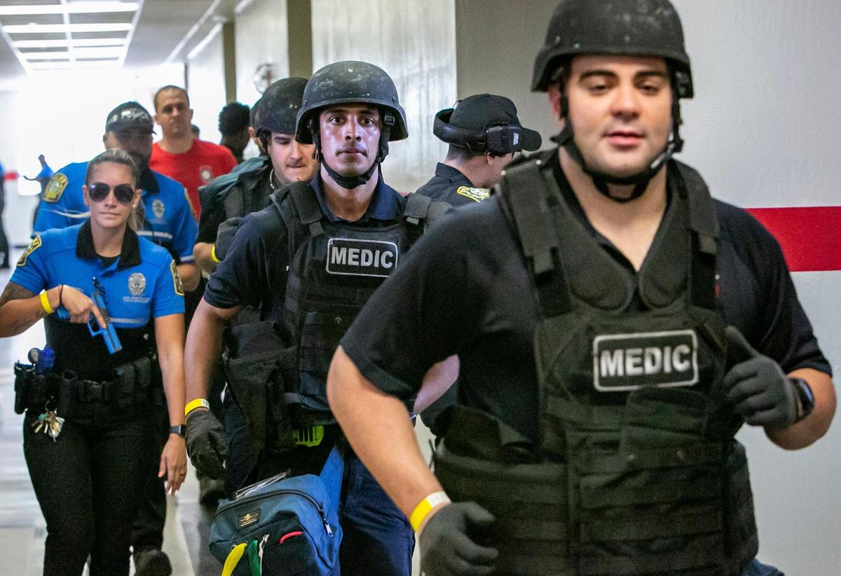 Medics rush to the scene to take care of victims during an active shooter drill held at Coral Gables Senior High School on Friday, July 15, 2022.