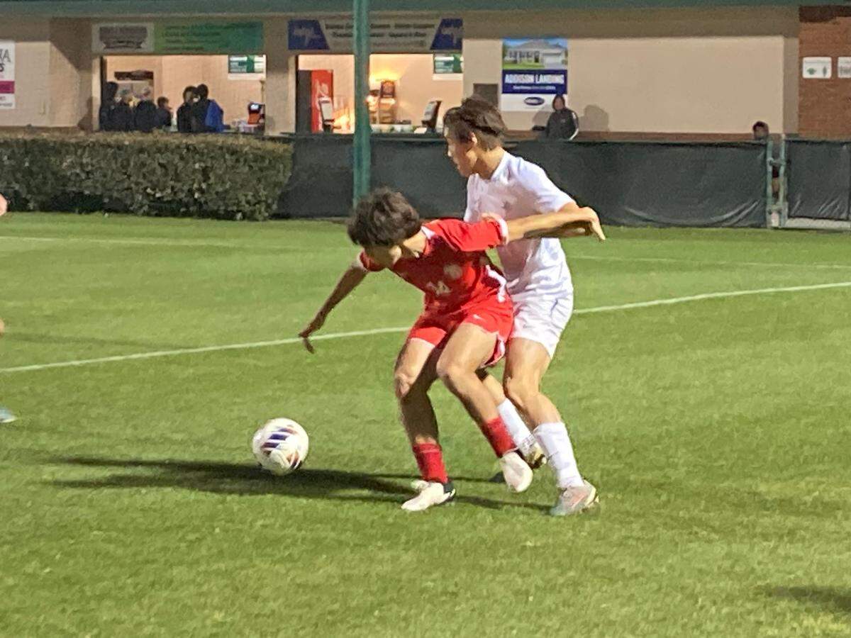 Doral Academy’s Gabriel Escalona fights for the ball during Thursday night’s Class 7A boys soccer semi at Spec Martin Stadium in DeLand, Fla.