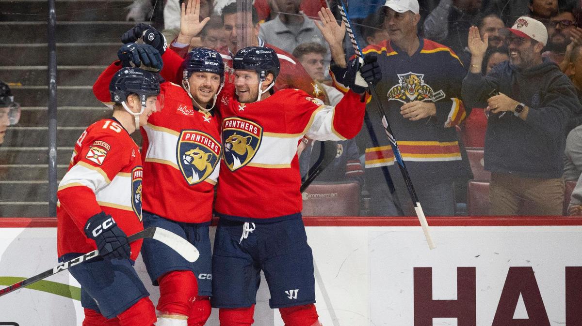 Florida Panthers center Sam Reinhart (13) celebrates his goal with center Anton Lundell (15) and defenseman Dmitry Kulikov (7) during the second period of a hockey game on Wednesday, Jan. 17, 2024, at Amerant Bank Arena in Sunrise, Fla.