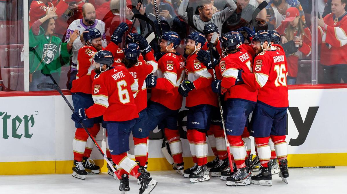 Florida Panthers center Carter Verhaeghe (23) celebrates with teammates after scoring the winning goal against Vegas Golden Knights goaltender Adin Hill (33) during overtime of Game 3 of the NHL Stanley Cup Final at the FLA Live Arena on Thursday, June 8, 2023, in Sunrise, Florida.