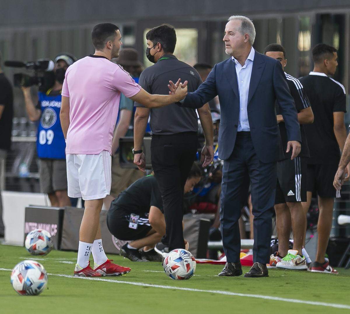 Inter Miami midfielder Lewis Morgan (7) greets Inter Miami co-owner Jorge Mas before the start of his MLS soccer match against New England Revolution at the DRV PNK Stadium on Wednesday, July 21, 2021, in Fort Lauderdale, Florida.