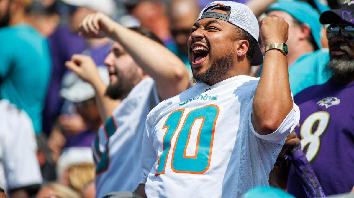 A Miami Dolphins fan shows his support after a play during second quarter of an NFL football game against the Baltimore Ravens at M&T Bank Stadium on Sunday, September 18, 2022 in Baltimore, MD.