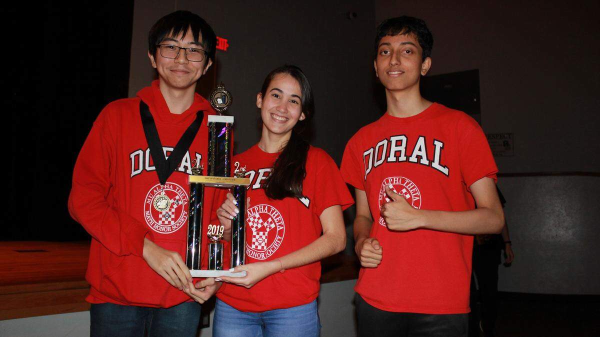 Middle and high school students from Doral Academy Preparatory School earned second place overall at the Golden Gate Region 5 Mu Alpha Theta Math Competition in Naples. From left: Math club officers Tae Lee, Liliana Sosa, and Anirudh Rahul with the second-place trophy.