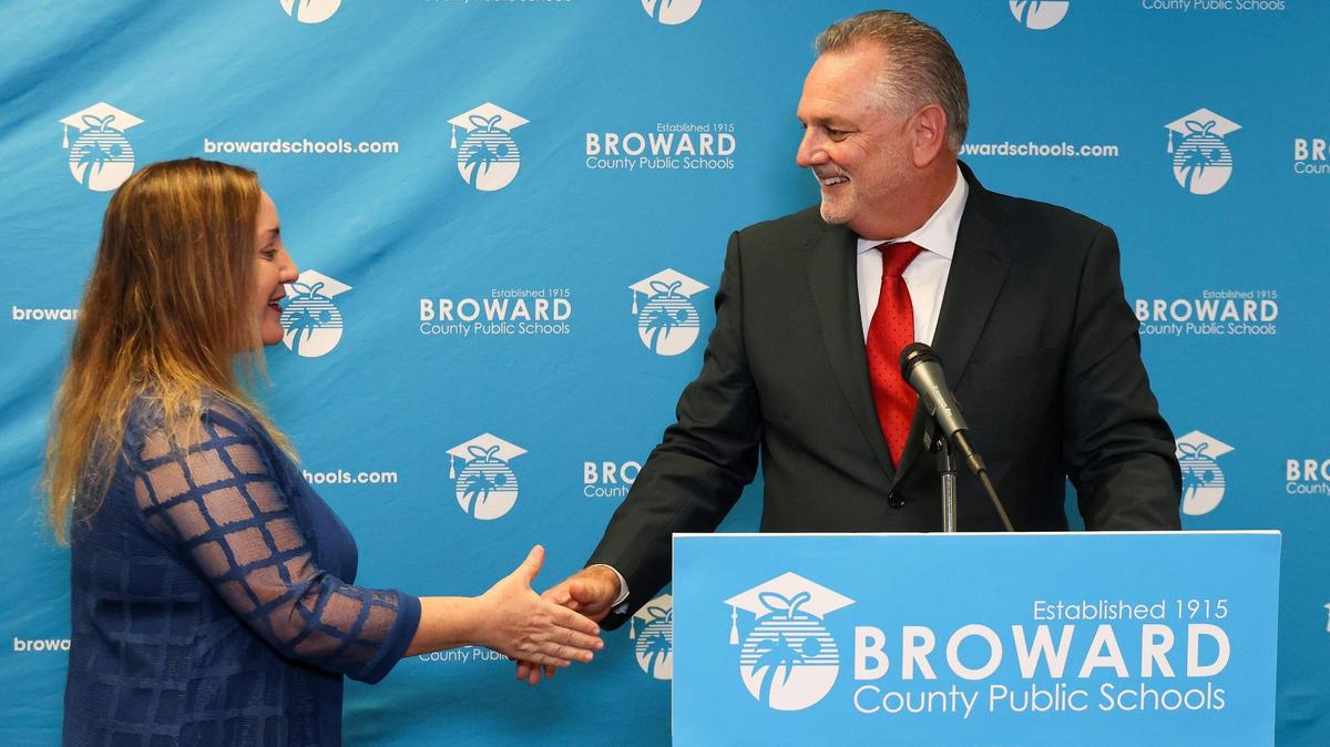 Broward School Board chair, Lori Alhadeff, District 4, left, shakes the hands of Peter Licata, right, after the board voted 7-2 to name him its new superintendent, Thursday, June 15, 2023, inside the School Board room at Kathleen C. Wright Building in Fort Lauderdale, Florida.