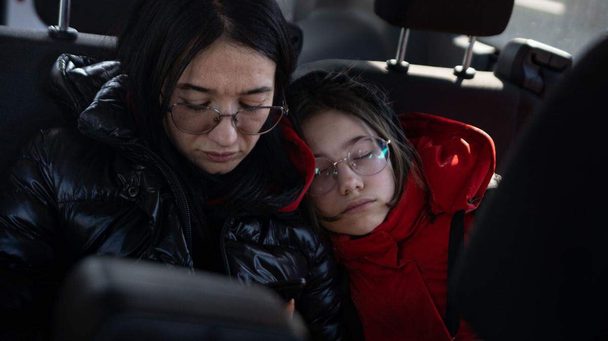 Shortly after starting their journey from the Ukrainian border to Germany in 2022, Anatasia Kopach, 11 cuddles up to her mother Tatiana, 39 as she sleeps.