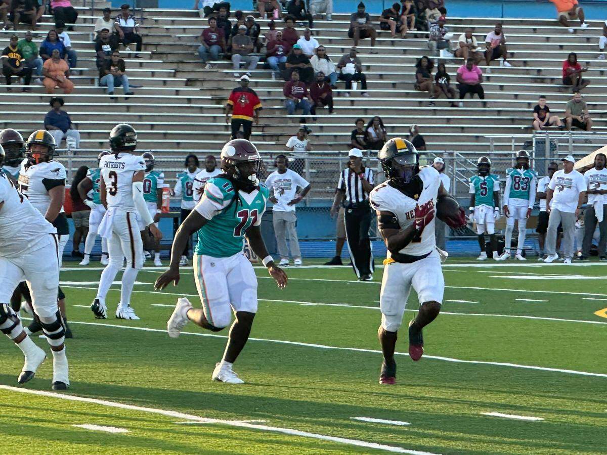 American Heritage running back Byron Louis breaks away from a defender during Monday night’s game against Miami Norland at Traz Powell Stadium.