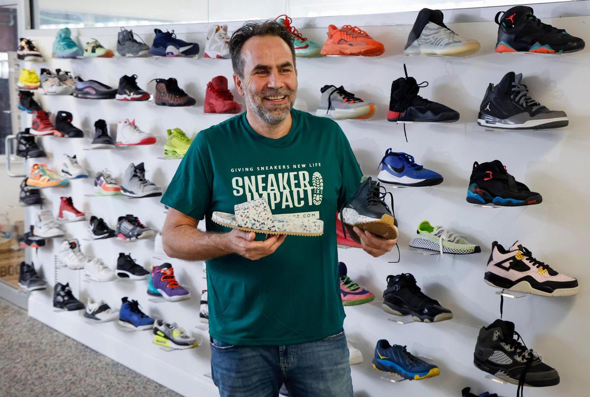 Moe Hachem, CEO and Founder of Sneaker Impact, holds products produced from post-consumer footwear at a 75,000 square foot recycling center in Little Haiti on Wednesday, April 2, 2025. People drop-off and ship their worn down sneakers to the warehouse. Employees fix and send some shoes to businesses around the world to resell or tear ones apart beyond repair into raw materials like rubber that is then sold.