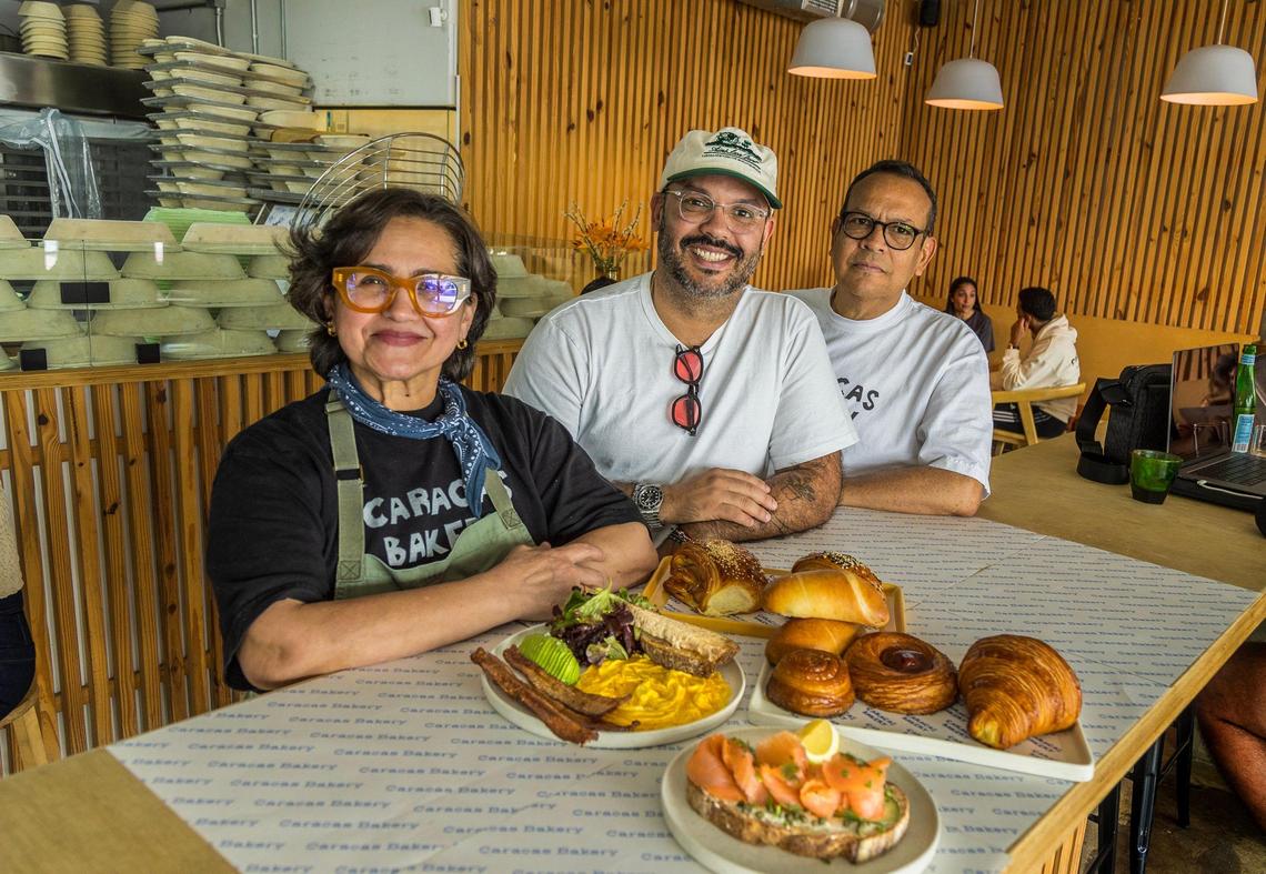 Jesús Brazón, center, with his parents Scarlet Rojas and Manuel Brazón at the Caracas Bakery in MiMo in 2024.