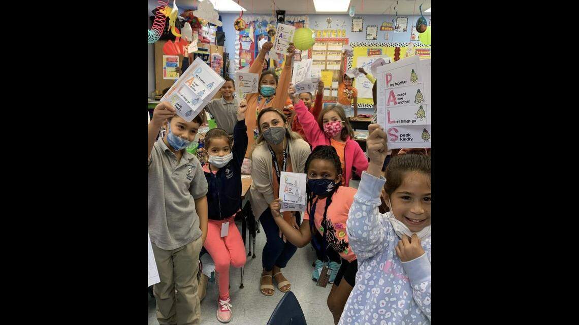 Somerset Academy Miramar South Guidance Counselor Amanda Garcia poses with a group of students showing their classwork. The charter school in Miramar is the No. 1 public elementary school in Broward County, according to new rankings by U.S. News & World Report. It also ranked at No. 2 for elementary charter schools in Florida and No. 5 for elementary schools statewide.