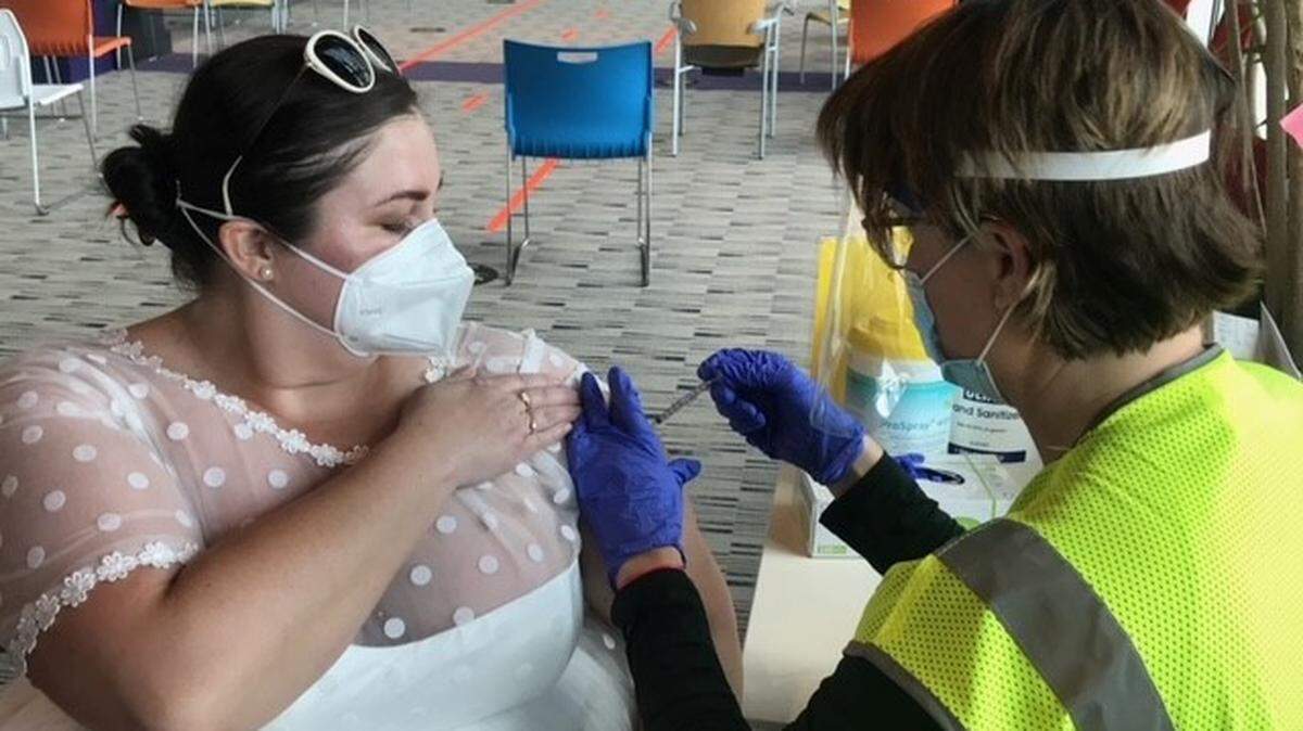 Sarah Studley received her COVID-19 vaccination at M&T Bank Stadium in Baltimore while wearing a wedding dress.