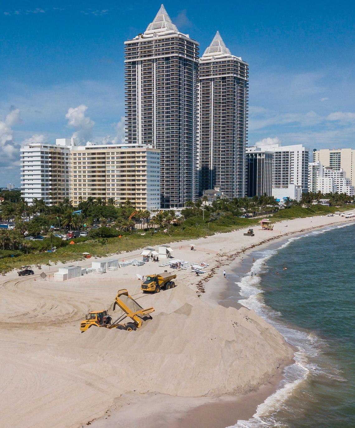 Aerial view shows trucks offloading sand near Indian Beach Park.