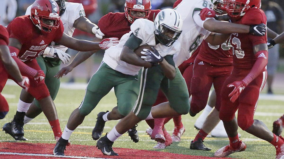 Miami Central Rockets running back Lexington Joseph (4) carries the ball against the Cardinal Gibbons Chiefs during the football game Saturday, Aug. 25, 2018, at Cardinal Gibbons High in Fort Lauderdale.