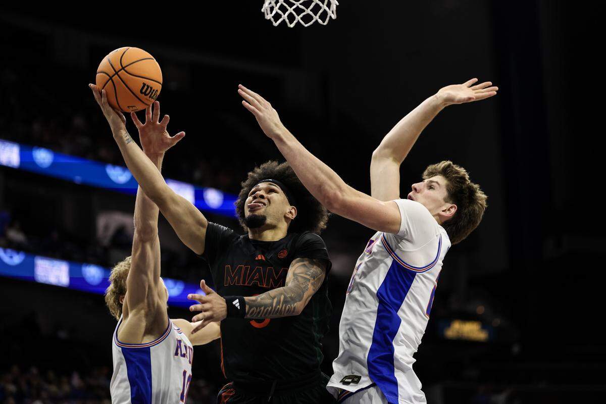 JACKSONVILLE, FLORIDA - NOVEMBER 16: Tre Donaldson #3 of the Miami Hurricanes shoots the ball agsainst Alex Condon #21 and Thomas Haugh #10 of the Florida Gators during the second half of a game in the Jacksonville Hoops Showdown at VyStar Veterans Memorial Arena on November 16, 2025 in Jacksonville, Florida. (Photo by James Gilbert/Getty Images)