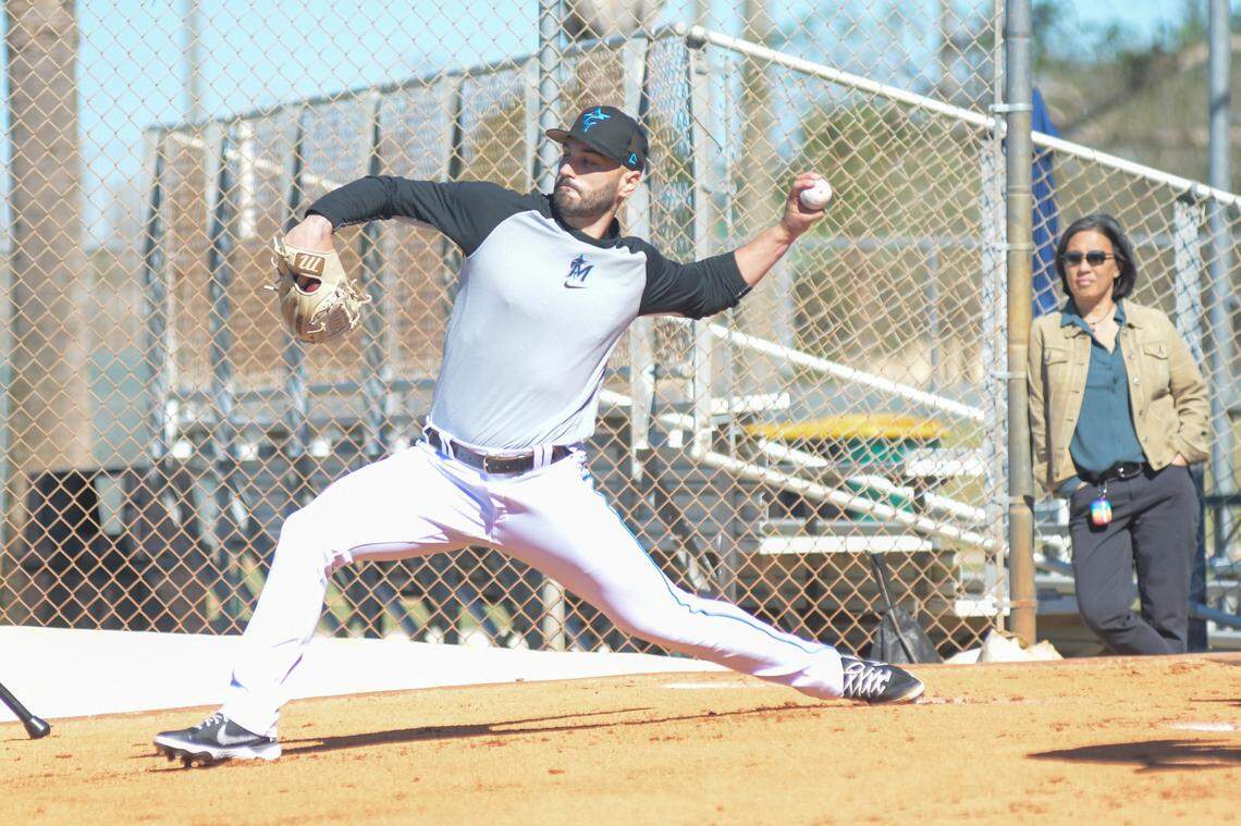 Miami Marlins left-handed pitcher Tanner Scott throws a bullpen session while general manager Kim Ng watches at the Roger Dean Chevrolet Stadium Complex on Monday, Feb. 13, 2023.