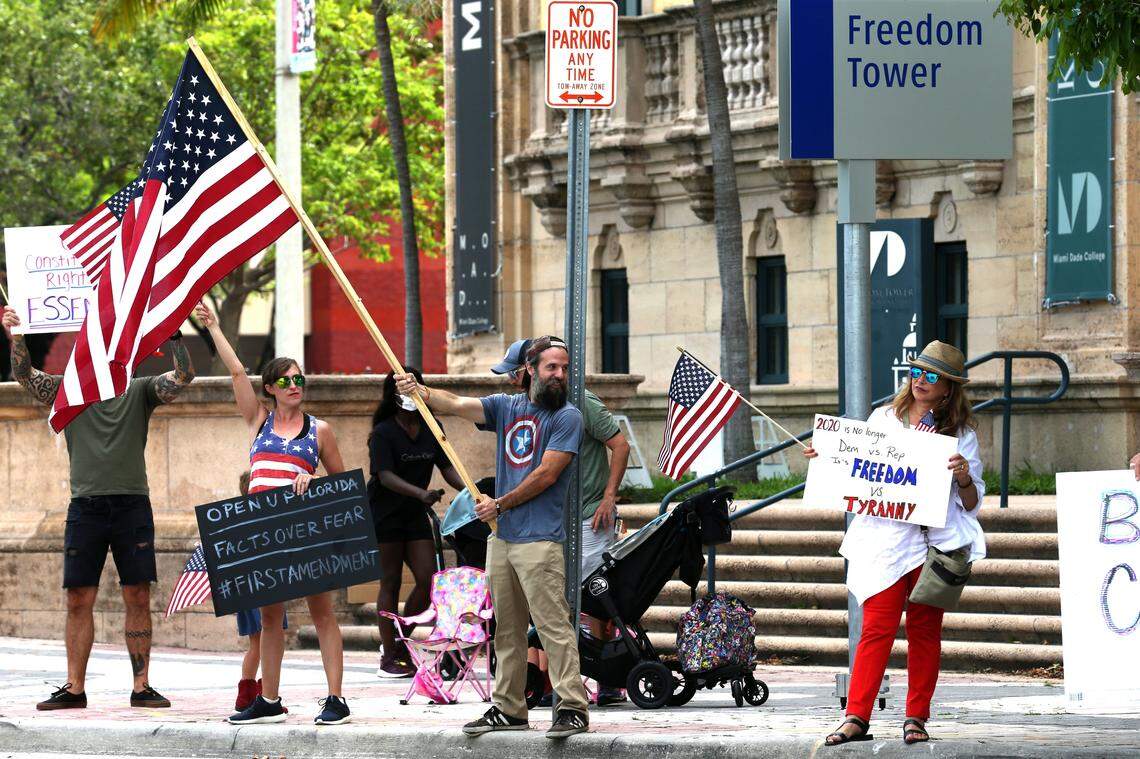 Protesters rally outside Freedom Tower in Downtown Miami requesting South Florida officials to lift restrictions and allow businesses to reopen and access to natural areas, on Sunday, May 3, 2020.