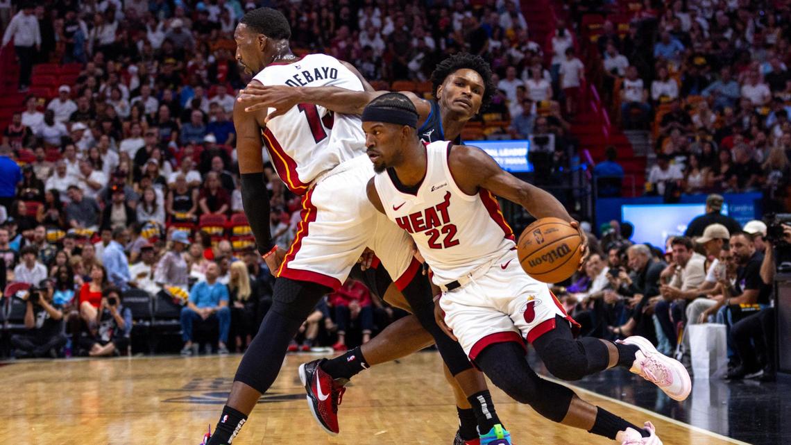 Miami Heat forward Jimmy Butler (22) uses a screen by teammate Bam Adebayo (13) as he drives around Detroit Pistons forward Ausar Thompson (9) during the first quarter of an NBA game at Kaseya Center in Miami, Florida, on Wednesday, October 25, 2023.
