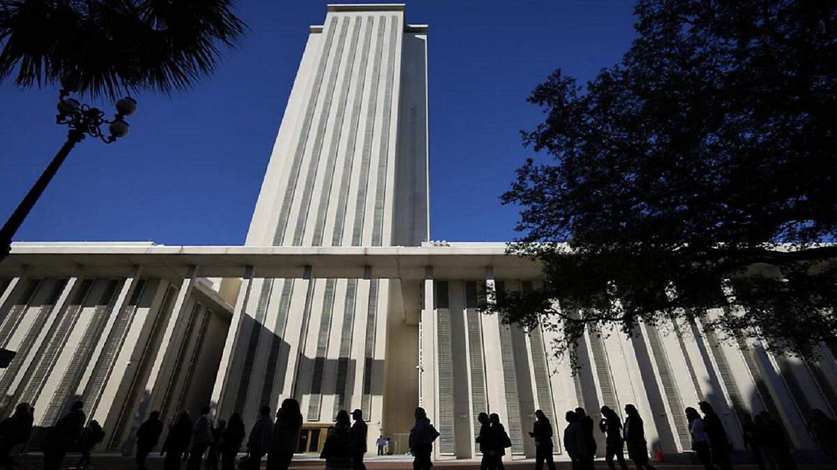 File photo of visitors walking in front of the Florida Capitol.