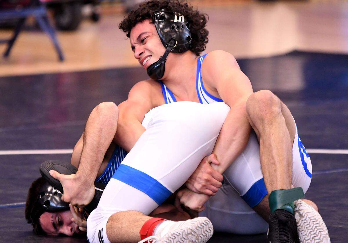South Dade’s Luis Acevedo clamps down on Osceola’s Evan Martinez during a 120-pound match in the 3A finals duel at the FHSAA Duals Wrestling State Championships on Saturday at Osceola High School in Kissimmee.