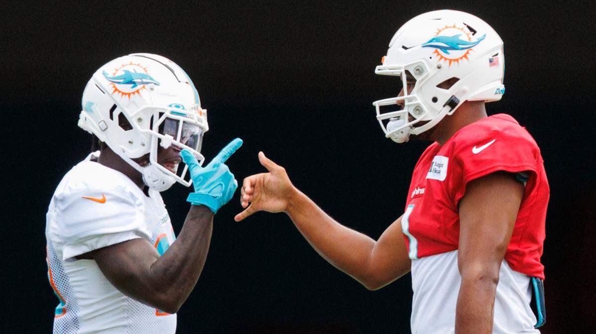 Miami Dolphins quarterback Tua Tagovailoa (1) greets teammate wide receiver Tyreek Hill (10) during NFL football training camp at Baptist Health Training Complex in Hard Rock Stadium on Sunday, August 7, 2022 in Miami Gardens, Florida.
