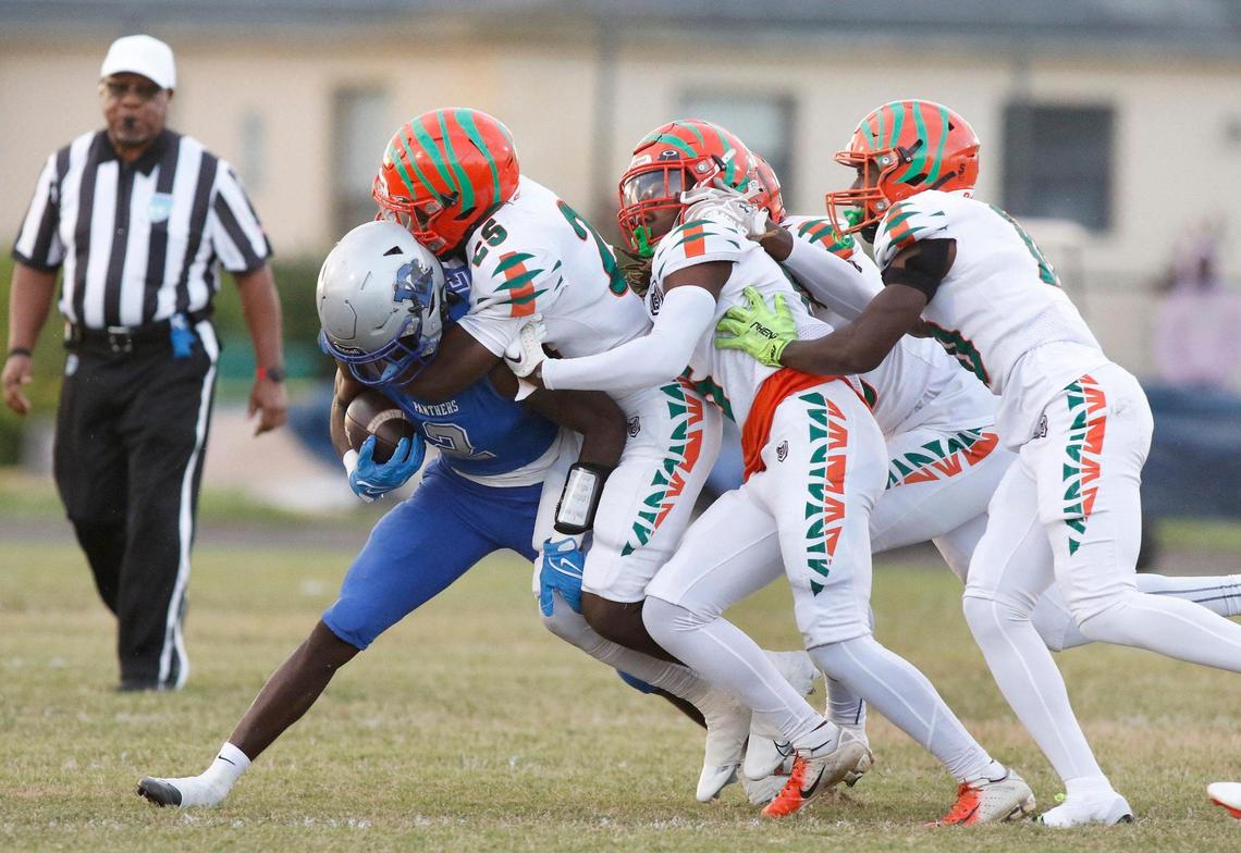 Blanche Ely Tigers defenders tackle Dillard Panthers running back Christopher Johanson during football playoff game on Saturday, November 19, 2022 at Dillard HS in Fort Lauderdale. Andrew Uloza / for Miami Herald