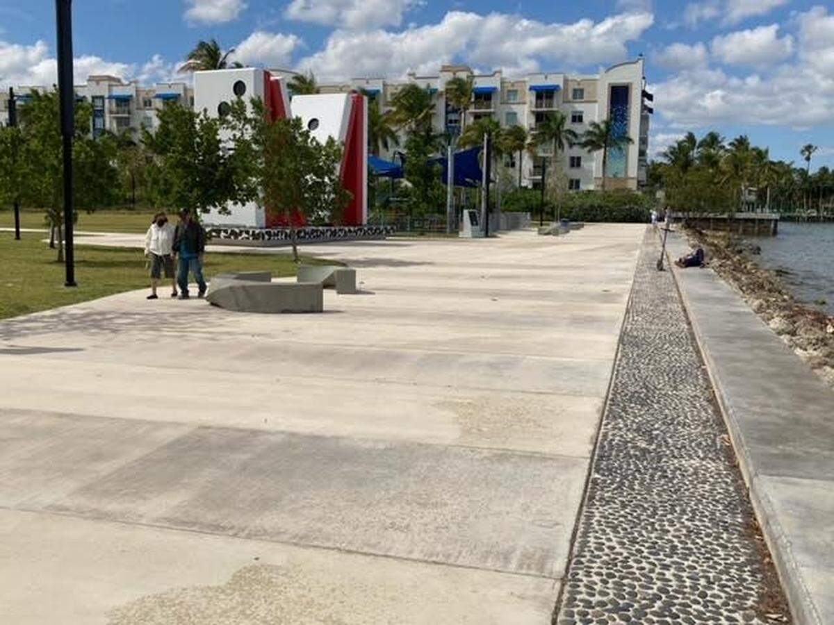 The paved baywalk is 30 feet wide, with the giant M monument in the background, at this Upper Eastside park that Miami city commissioners want to rename Jose Milton Park at E. Albert Pallot Green Space. Credit: Geoffrey Bash.