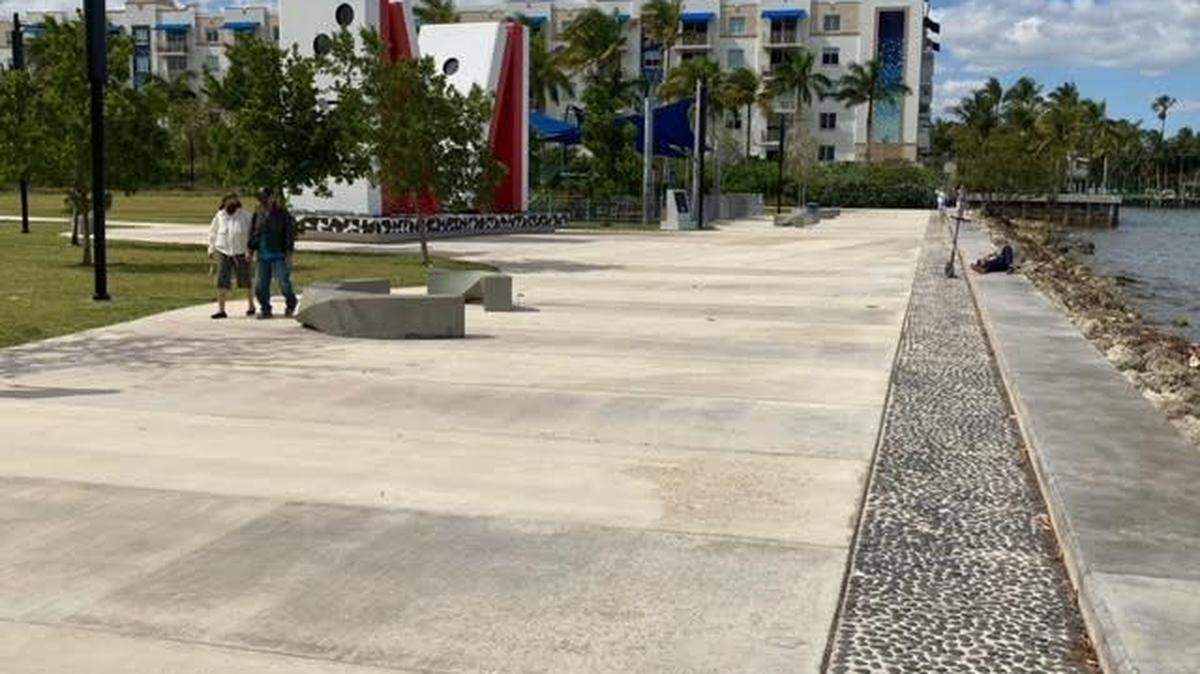 The paved baywalk is 30 feet wide, with the giant M monument in the background, at this Upper Eastside park that Miami city commissioners want to rename Jose Milton Park at E. Albert Pallot Green Space. Credit: Geoffrey Bash.