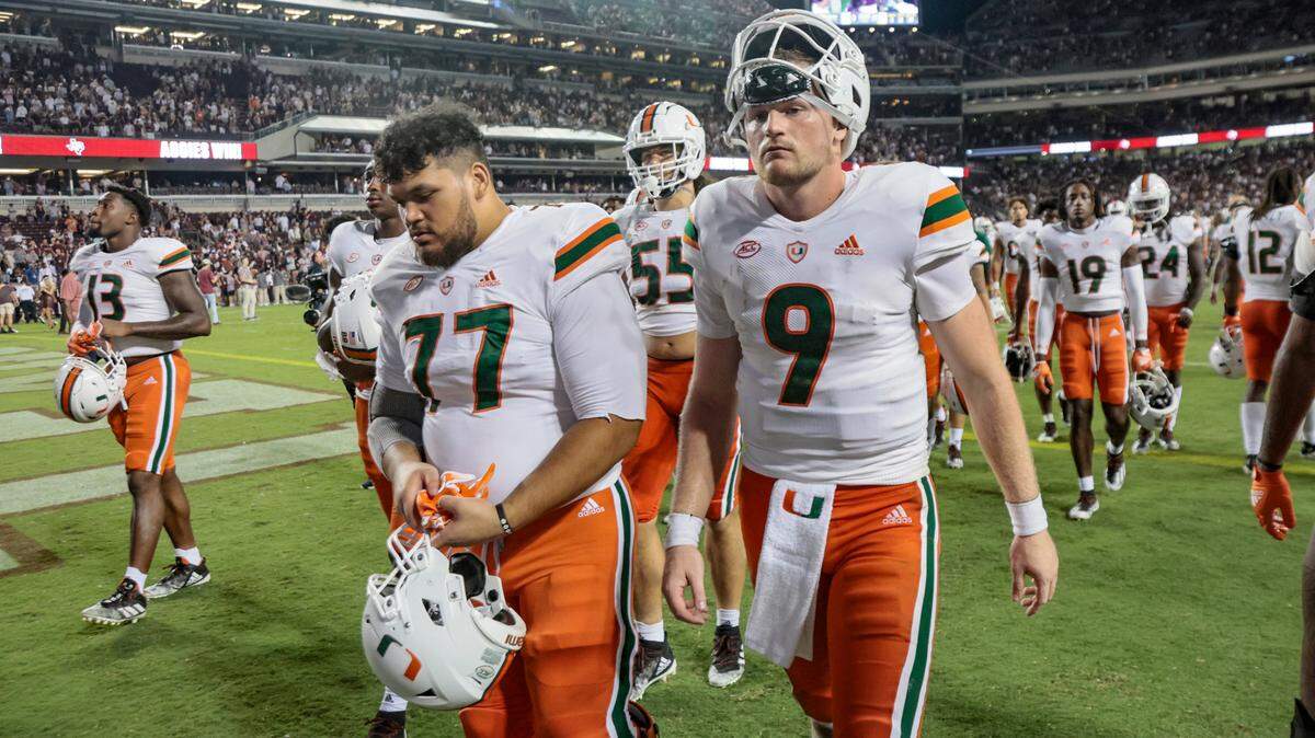 Miami Hurricanes offensive lineman Logan Sagapolu (77) and quarterback Tyler Van Dyke (9) walk off the field after being defeated by the Texas A&M Aggies at Kyle Field in College Station, Texas on Saturday, September 17, 2022.