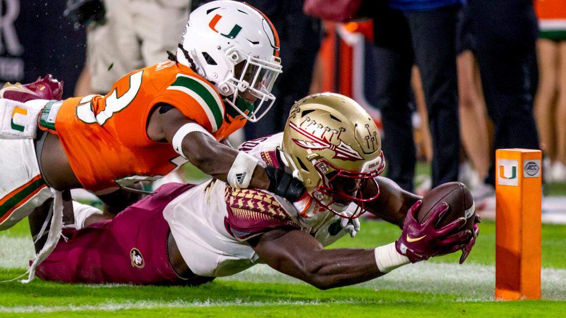 Florida State University running back Trey Benson (3) dives for the touchdown while tackled by University of Miami defensive back Te’Cory Couch (23) during the second quarter of an ACC football game at Hard Rock Stadium in Miami Gardens on Saturday, November 5, 2022.