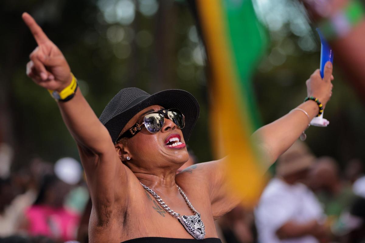 A woman raises her arms while dancing during the 19th annual Best of the Best International Music Festival at Bayfront Park in downtown Miami, Sunday, May 25, 2025. This year’s event attracted thousands of dancehall reggae and soca music fans from across generations.