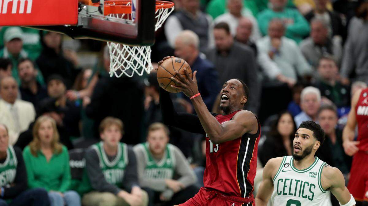 Miami Heat center Bam Adebayo (13) drives past Boston Celtics forward Jayson Tatum (0) during the second half in game one of the Eastern Conference Finals for the 2023 NBA playoffs at TD Garden.