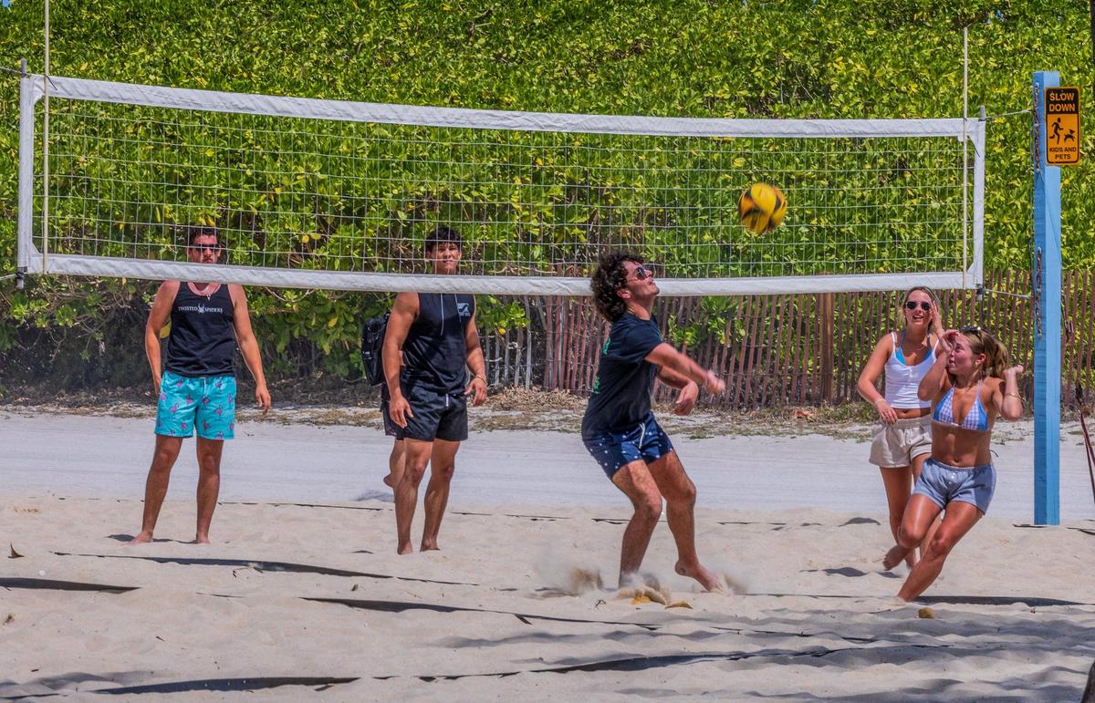 A group of people play beach volleyball at Lummus Park as they enjoy the nice weather in South Beach, during spring break, in Miami Beach, Florida, on Saturday March 22, 2025.