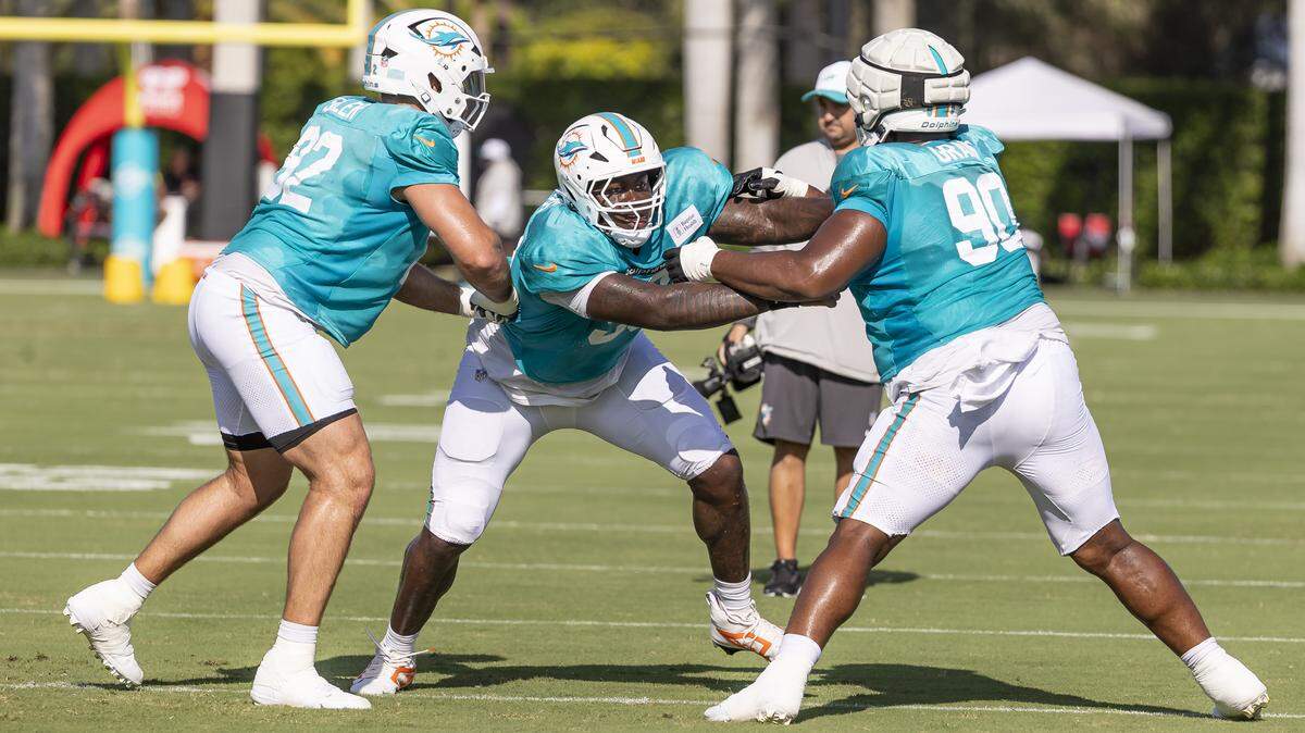Miami Dolphins defensive tackles Zach Sieler (92), Zeek Biggers (93) and Kenneth Grant (90) run drills during training camp at the Baptist Health Training Complex on Tuesday, July 29, 2025, in Miami Gardens, Fla.