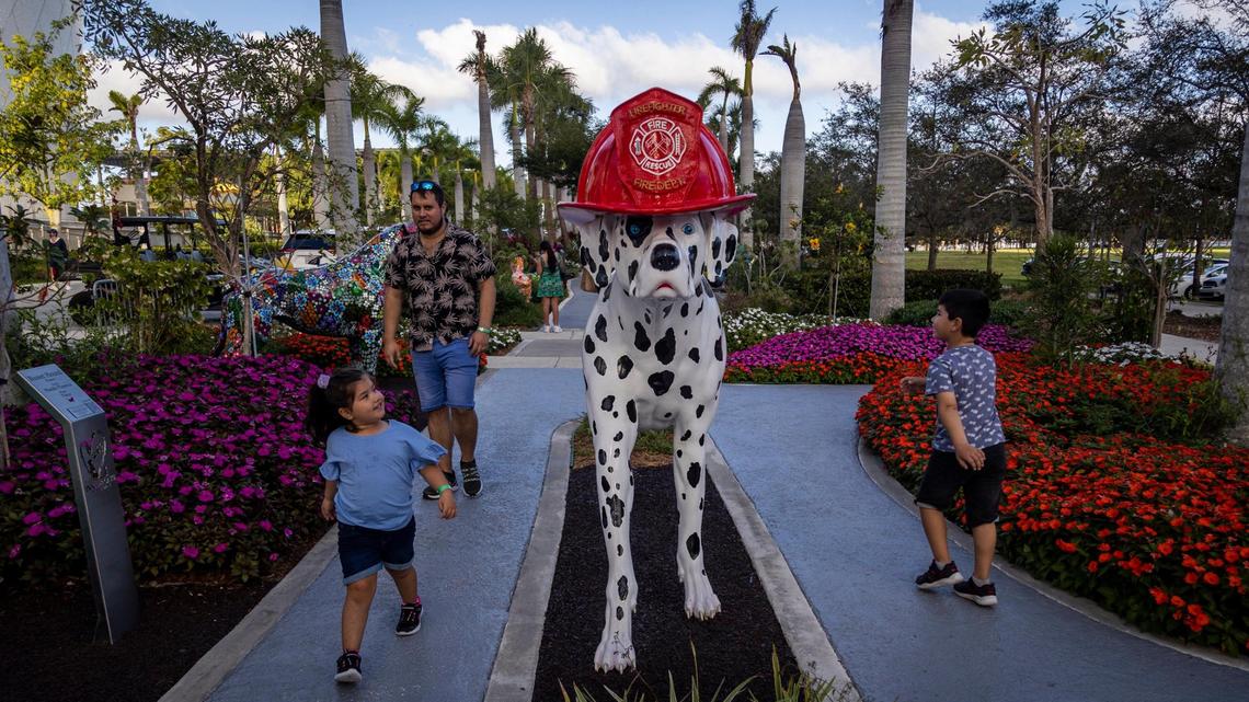 Children check out the statue of a Dalmatian at the Dogs and Cats Walkway and Sculpture Gardens in Miami.