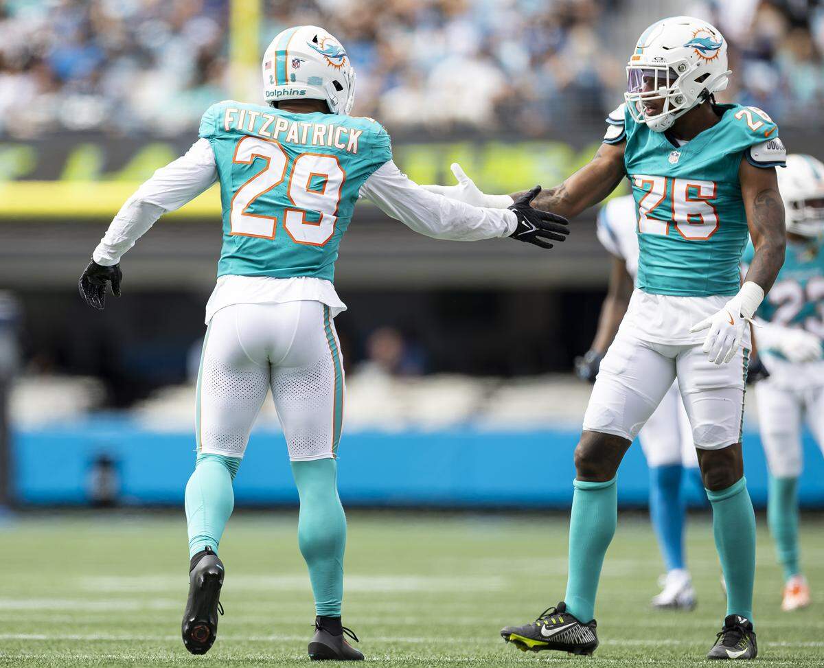 Miami Dolphins free safety Minkah Fitzpatrick (29) celebrates with cornerback Rasul Douglas (26) after a play in the second half of their NFL game at the Bank of America Stadium on Sunday, Oct. 5, 2025, in Charlotte, N.C.