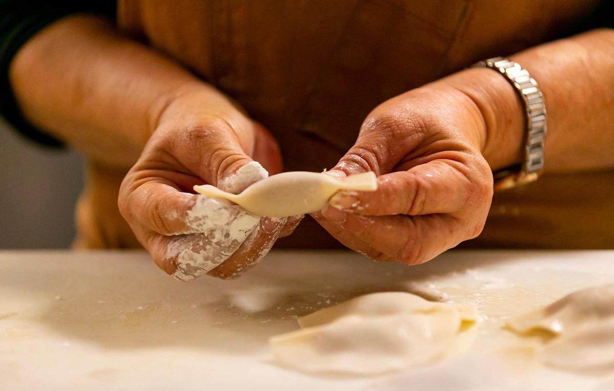 Elsa Lopez, 62, prepares chicken dumplings at Zitz Sum.