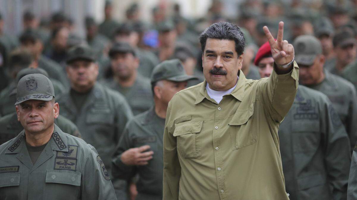 Venezuela’s President Nicolás Maduro flashes a V for Victory hand gesture after arriving at the Fort Tiuna military base in Caracas, Venezuela, Wednesday, Jan. 30, 2019.